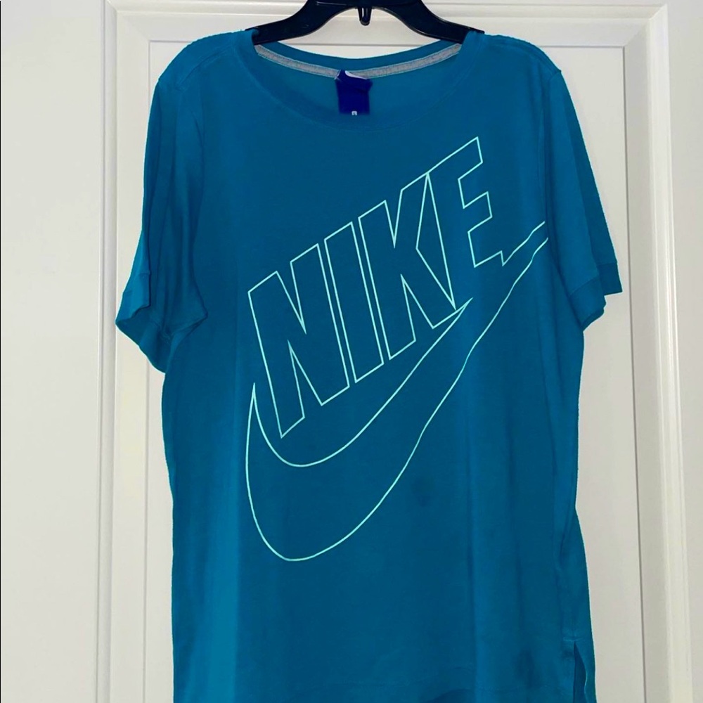 Womens blue Nike sports shirt with slit in on sides.